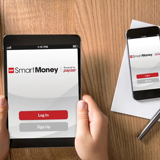 Hand holding tablet with GAF SmartMoney on screen